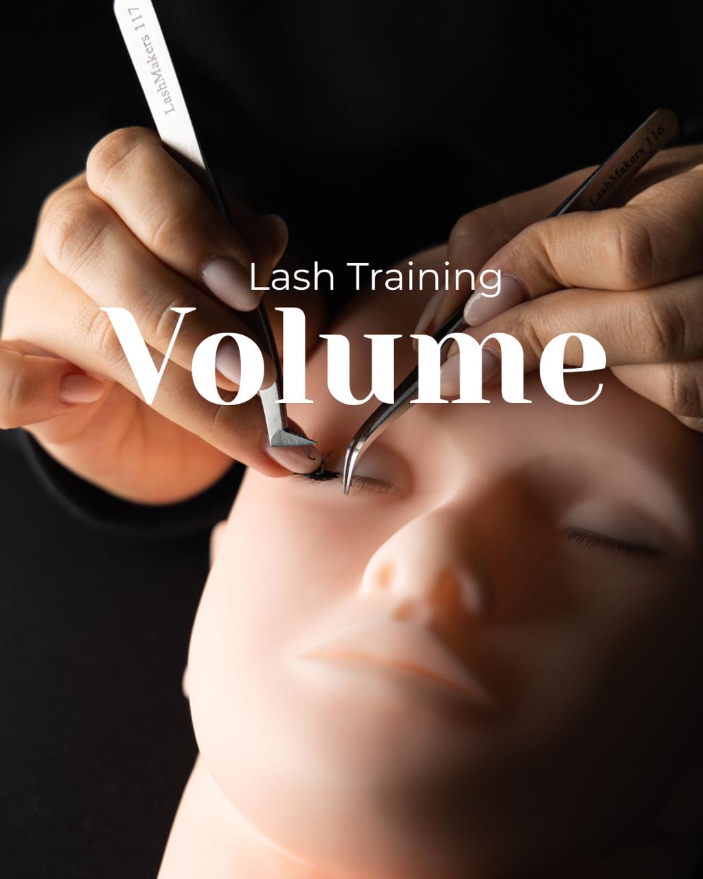 Volume lash training with hands applying eyelash extensions on a mannequin head