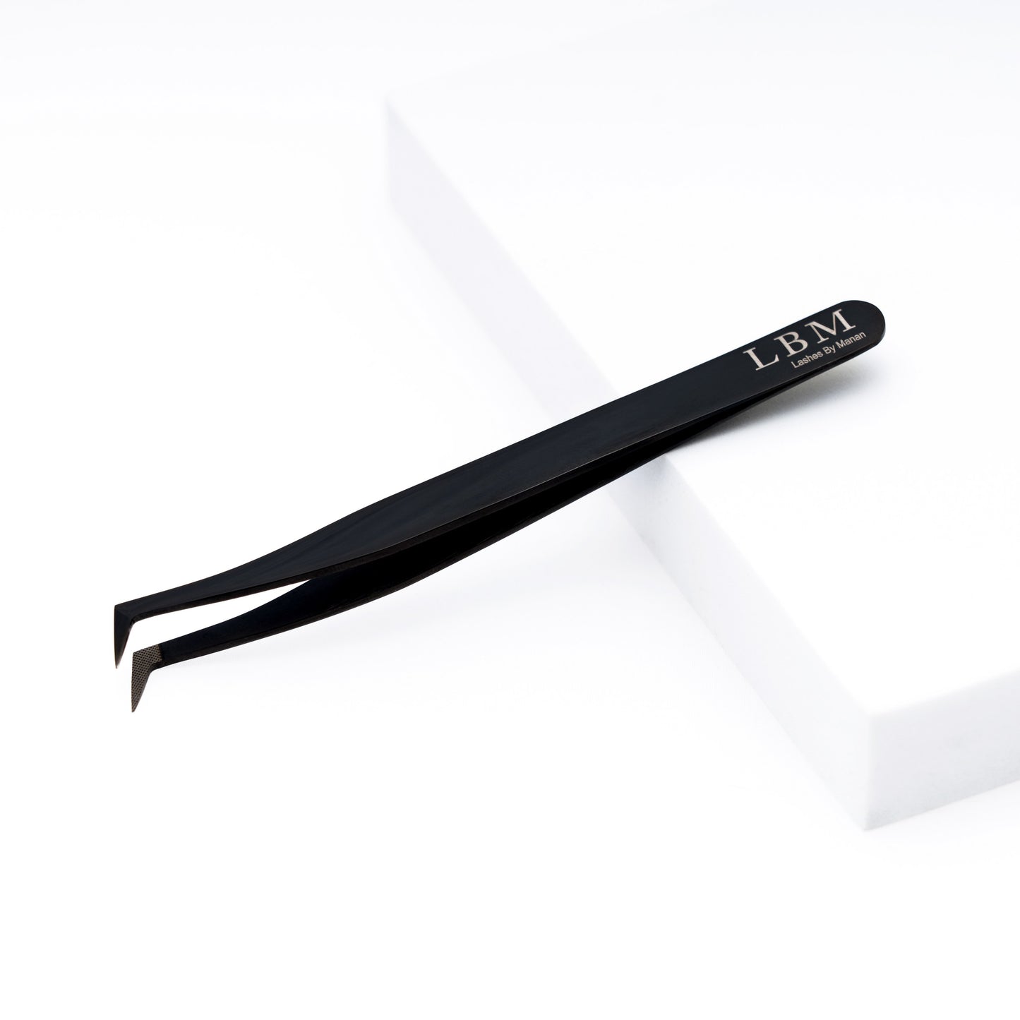 Black eyelash tweezer with 'LBM' branding on a white background