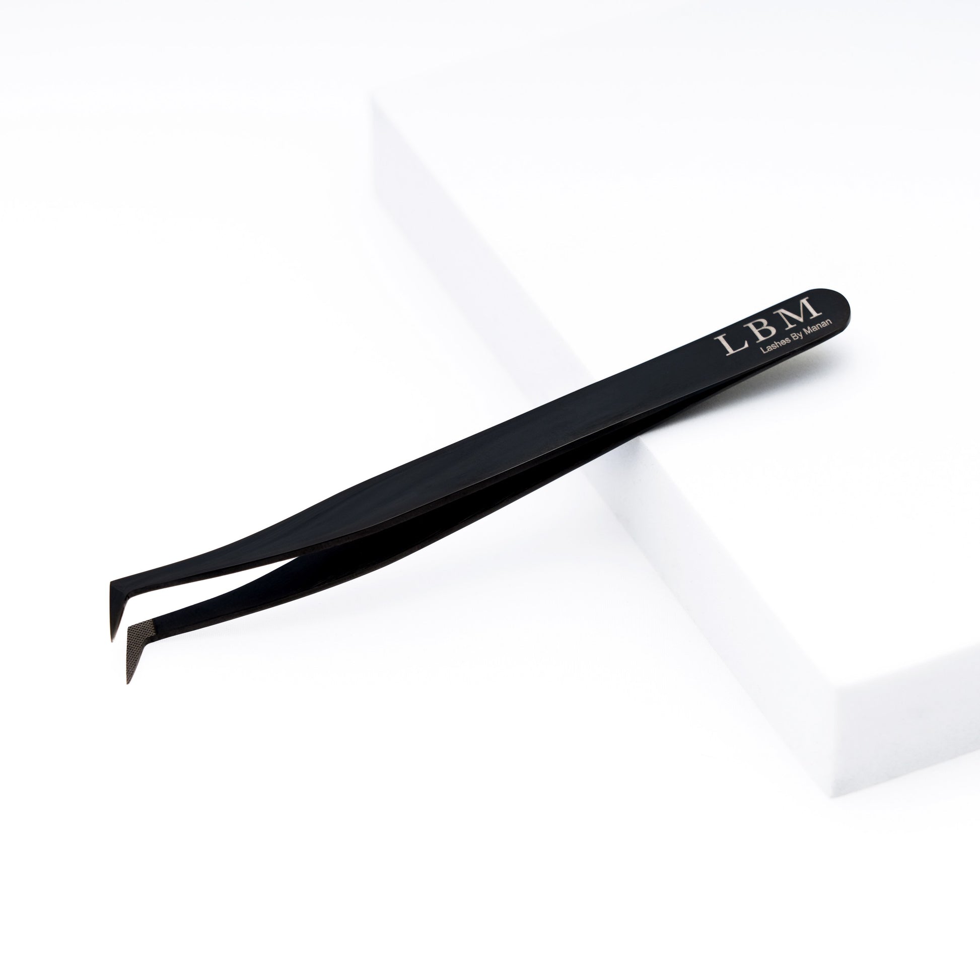 Black eyelash tweezer with 'LBM' branding on a white background