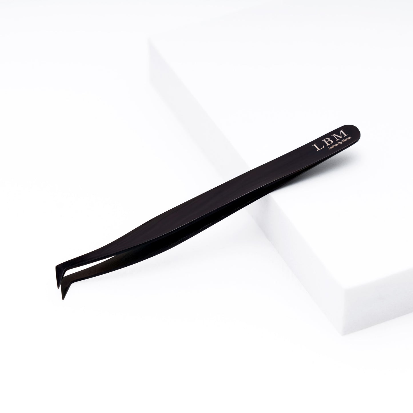 Black slant-tip tweezers with 'LBM' branding on a white background