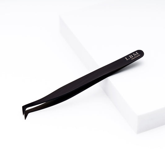 Black slant-tip tweezers with 'LBM' branding on a white background