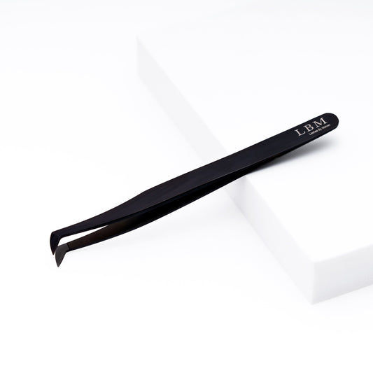 Black slant-tip tweezers with 'LBM' branding on a white background