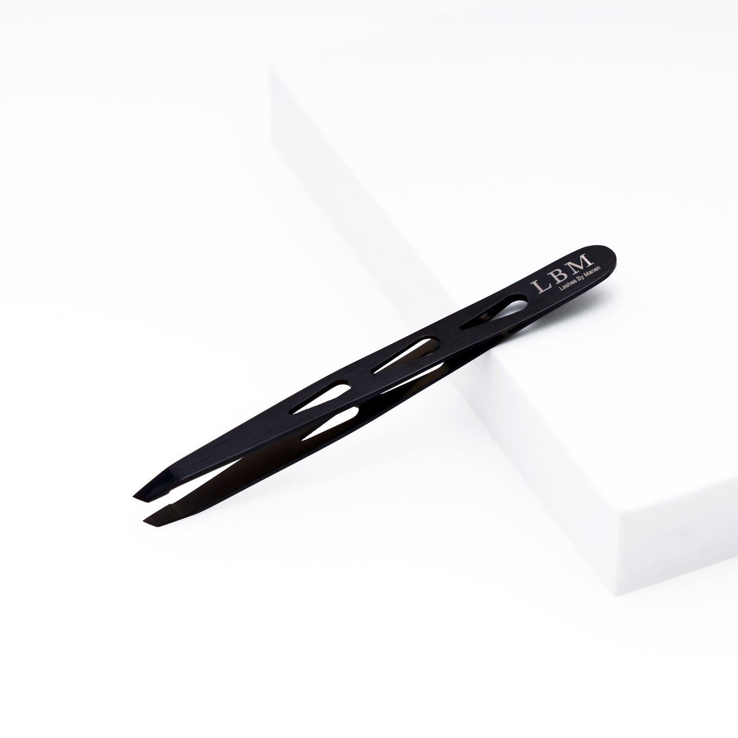 Black slant-tip tweezers with 'LBM' branding on a white background