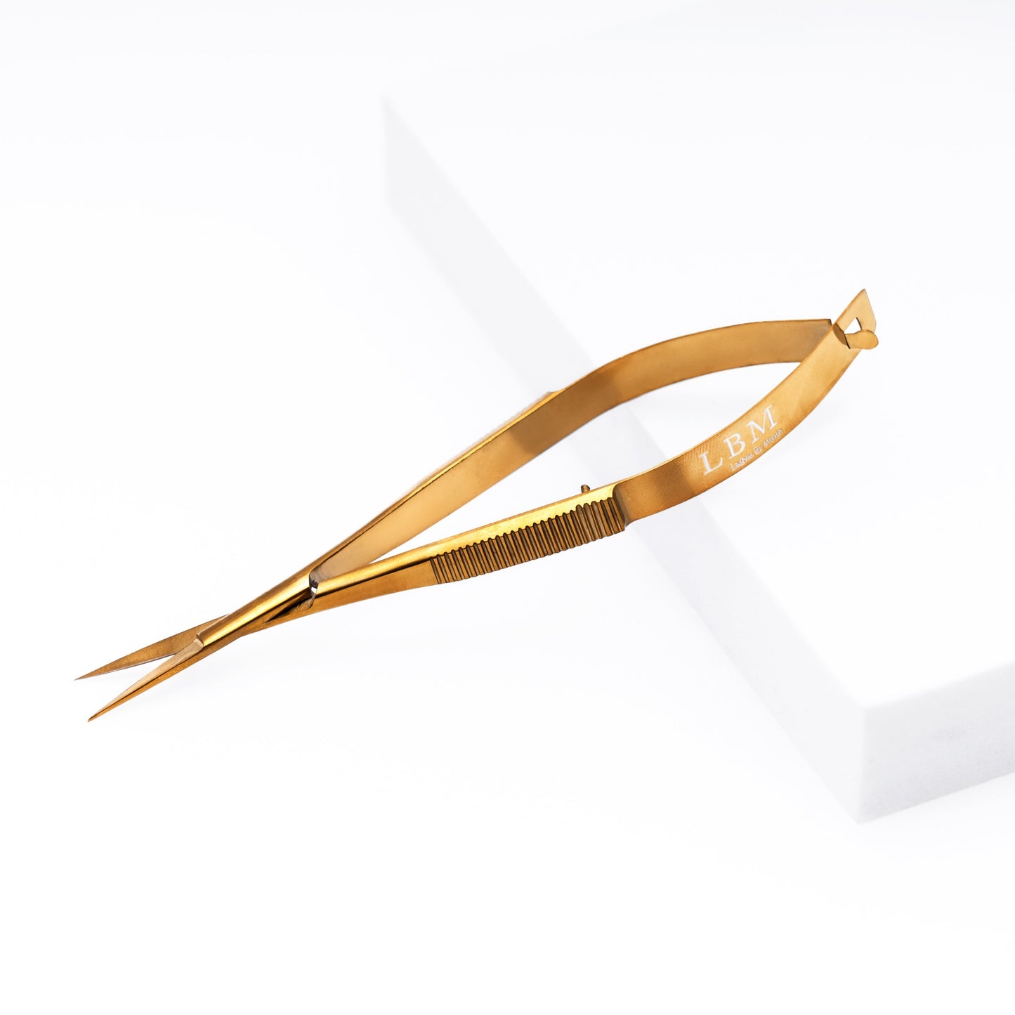 Gold-colored Eyebrow Scissors on a white background