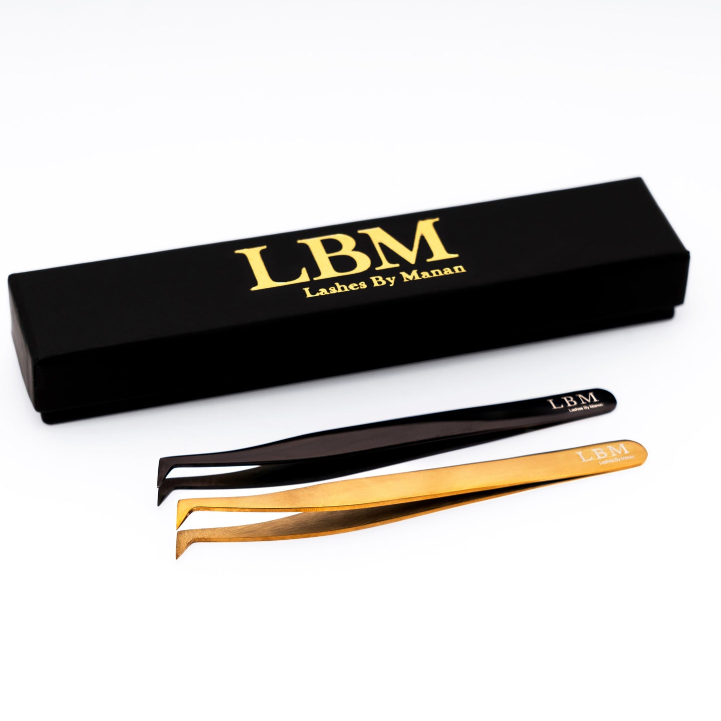 Eyelash extensions tweezers with black and gold options and a black box labeled 'Lashes By Manan' on a white background.